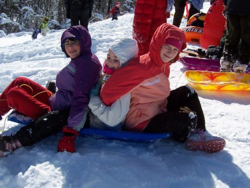 Children Sledding in the Snow